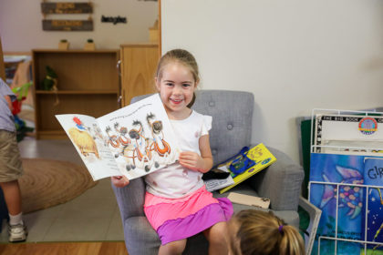 Child with book during preschool story time
